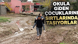 Yol yapılmayınca okula giden çocuklarını sırtlarında taşıyorlar