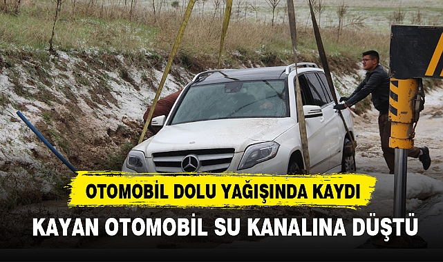 OTOMOBİL DOLU YAĞIŞINDA KAYAN OTOMOBİL SU KANALINA DÜŞTÜ