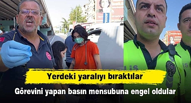 Yerdeki yaralıyı bırakıp, görevini yapan basın mensubuna engel oldular