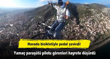Havada bisikletiyle pedal çevirdi! Yamaç paraşütü pilotu görenleri hayrete düşürdü